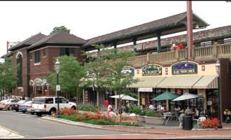South Orange, NJ A charming streetscape in South Orange, NJ, featuring historic brick buildings, local shops, and outdoor dining areas, creating a vibrant community atmosphere.